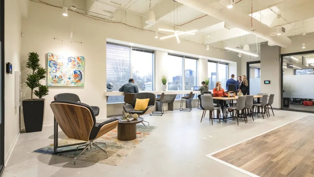 View of the open cafe area next to Coworking seating and outdoor views of the city.