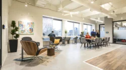 View of the open cafe area next to Coworking seating and outdoor views of the city.