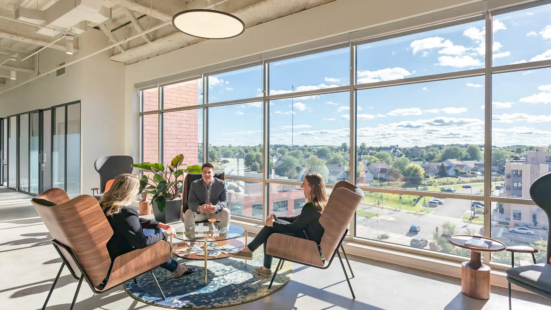 Meeting in Coworking area with three members. West Madison Private Office & Coworking Space