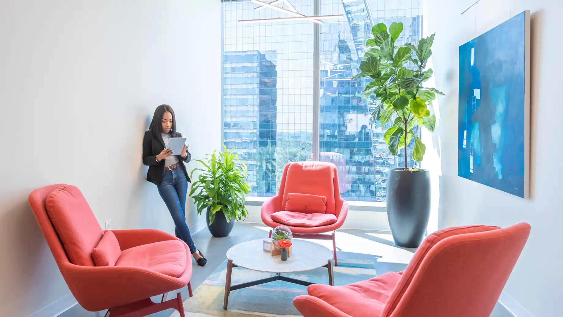 Buckhead Atlanta Private Office & Coworking Space. Members working independently at open Coworking desks with low seating and outdoor views.