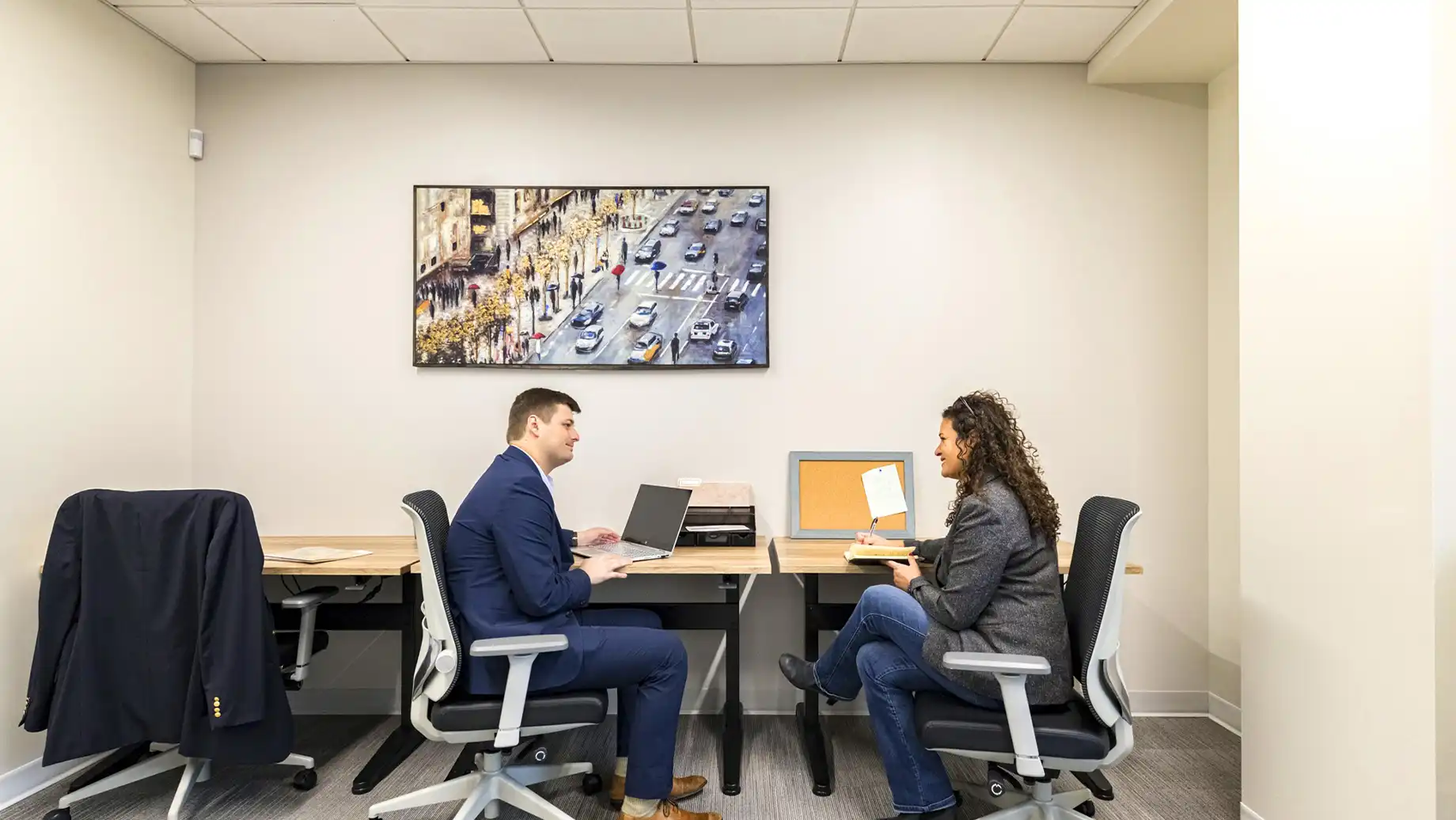 Man and woman conversing in a private Team Room.