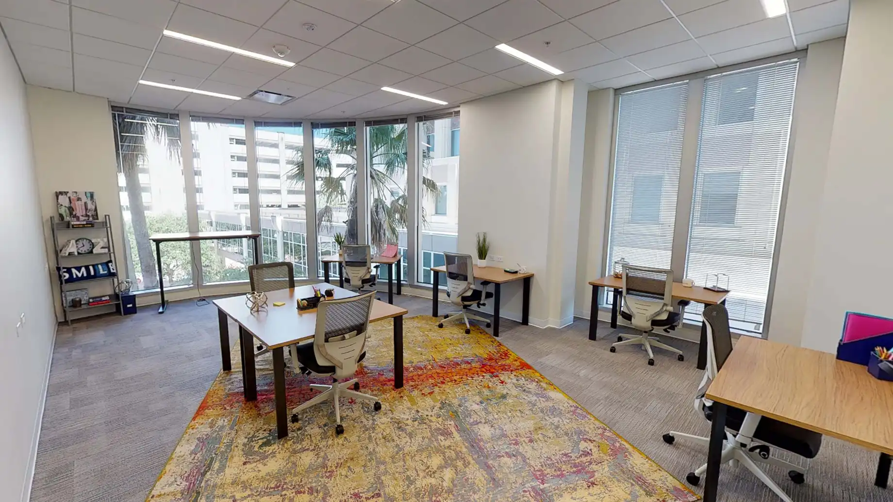 Downtown Orlando Private Office & Coworking Space, 6 person Team Room with private desks and open windows overlooking the city.