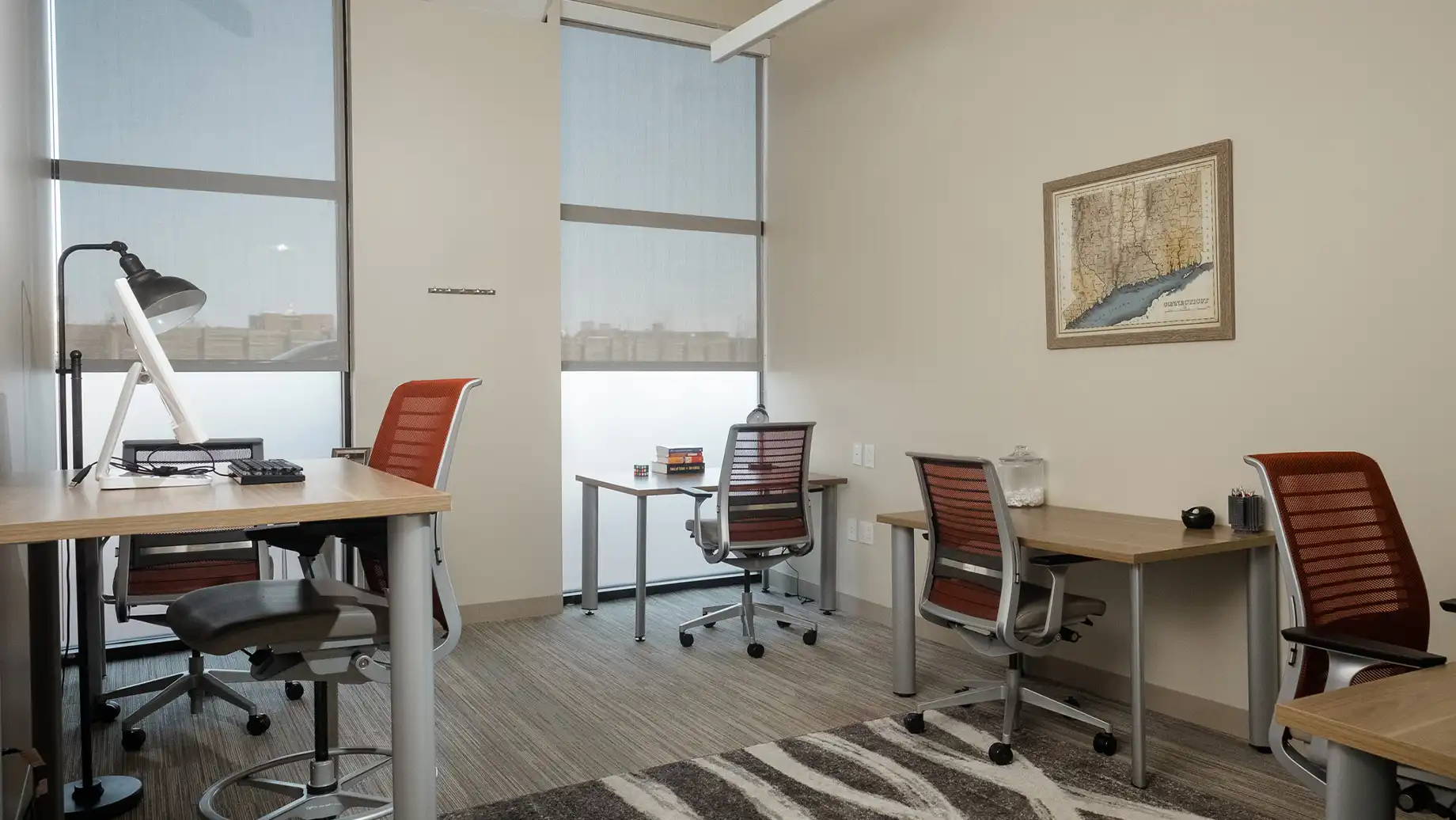 Private three person office with separate desks and outdoor views. Stamford Private Office & Coworking Space Serendipity Labs