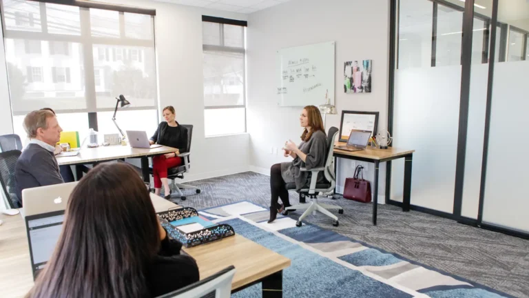 Woman working in a two person private office with an outdoor view. Westport Connecticut Private Office & Coworking Space Serendipity Labs