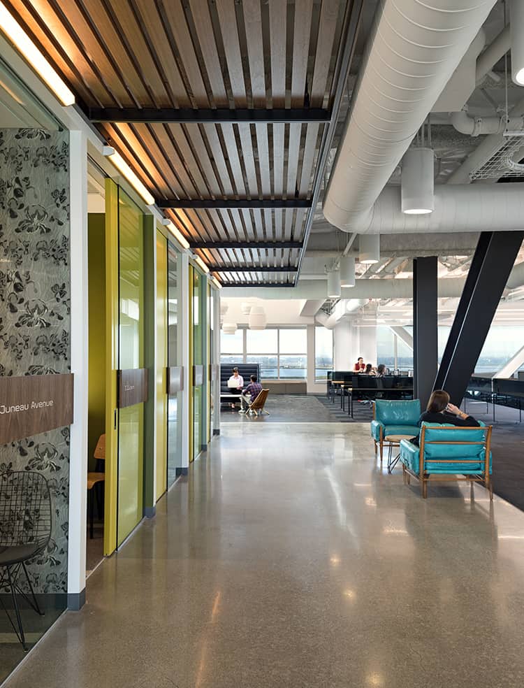 Brightly lit with floor-to-ceiling windows and clad with original wallpaper prints, the new office space of DIY company Zazzle masters the balance between work and play.