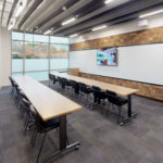 Open Ideation studio with high and low seating and built in A/V system for meetings.