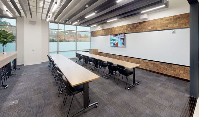Open Ideation studio with high and low seating and built in A/V system for meetings.