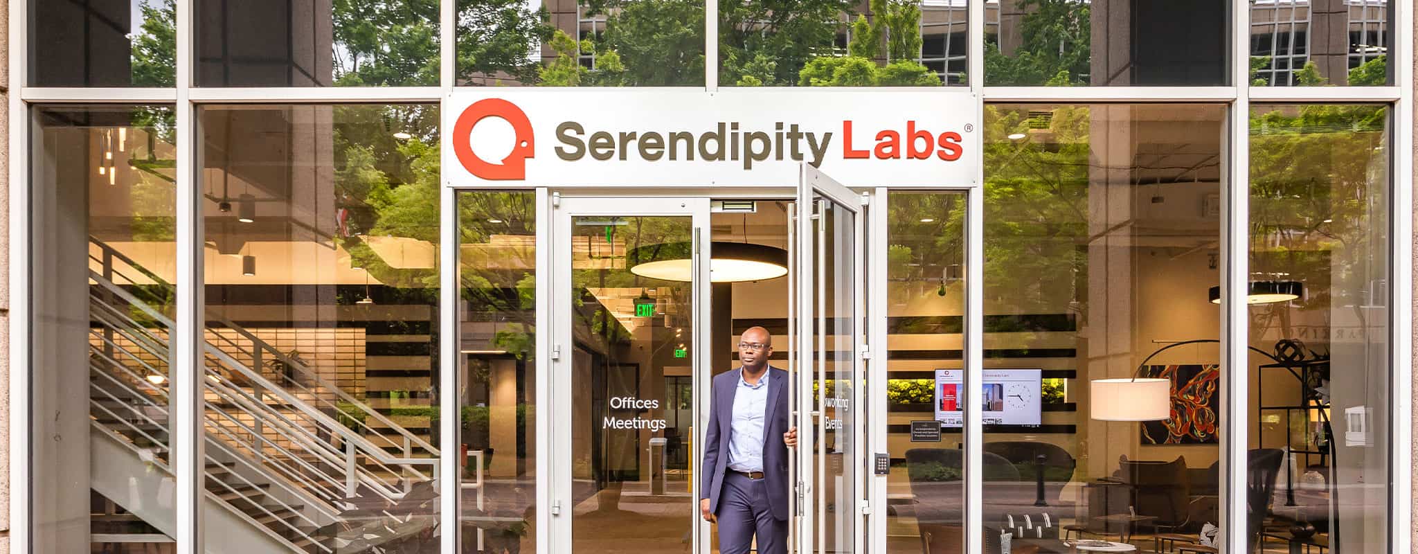 Man walking out the front doors of Serendipity Labs.