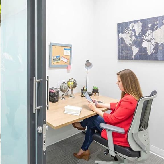 Woman working in a one person private office.