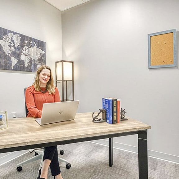 Woman working independently in private one person office.