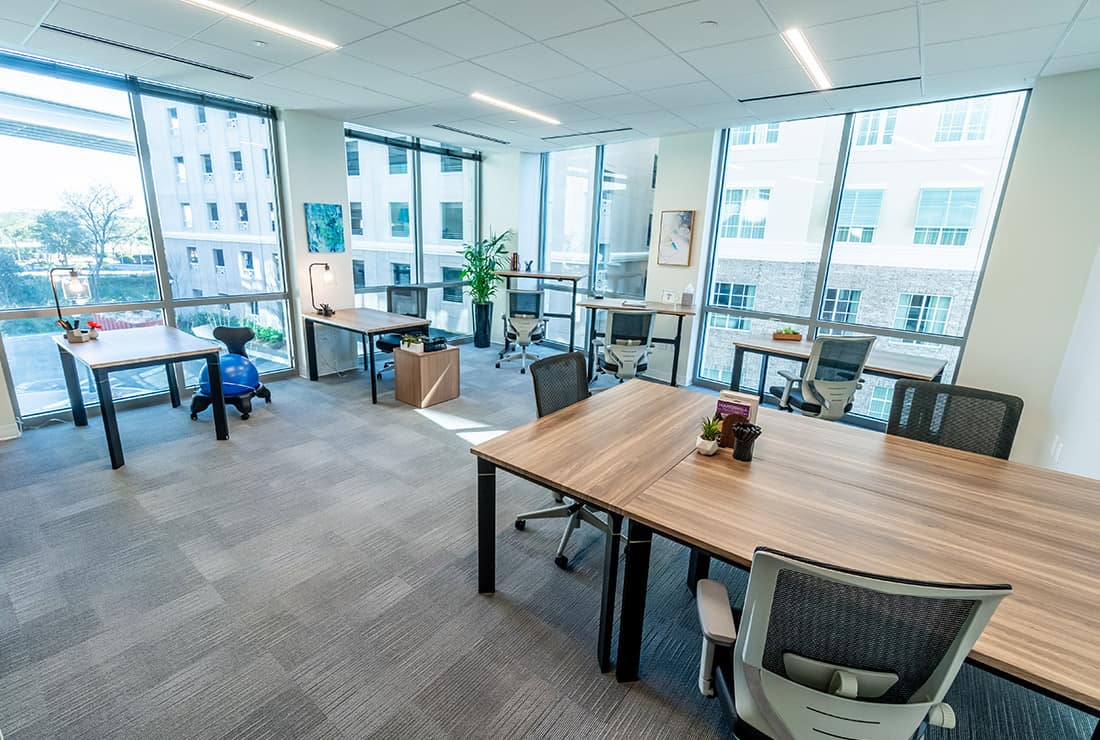Large open Team Room with large windows facing the city.